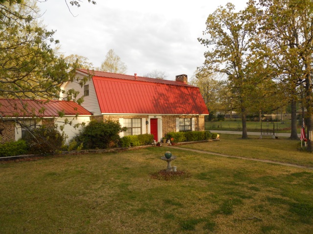 Sunset and full house picture of red metal reroof