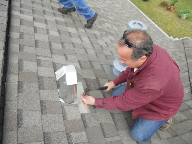 Alternative picture from rooftop of Grumbles team inspecting roof